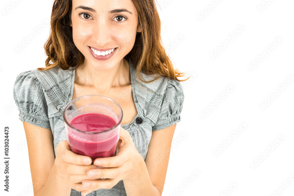Happy healthy woman showing a glass of smoothie Happy healthy woman showing a glass of smoothie