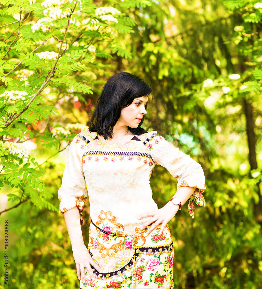 Beautiful woman standing in a park in spring or summer Beautiful woman standing in a park in spring or summer