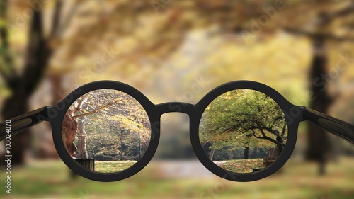 Fototapeta Naklejka Na Ścianę i Meble -  Closeup on eyeglasses with focused and blurred landscape view.