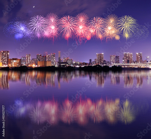 Fireworks celebrating over Tokyo cityscape at nigh