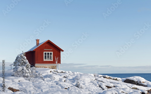 Winter in the archilelago and red cottage