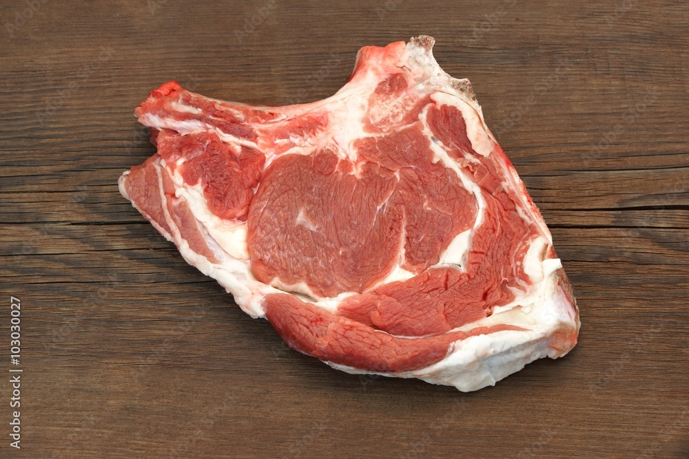 Raw Beef Steak On The Wood Cutting Board, Top View Raw Beef Steak On The Wood Cutting Board, Top View