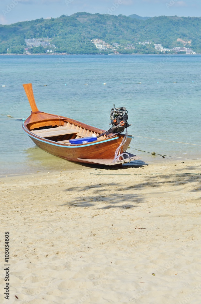 Thai boat on the beach against the backdrop of sea and mountains