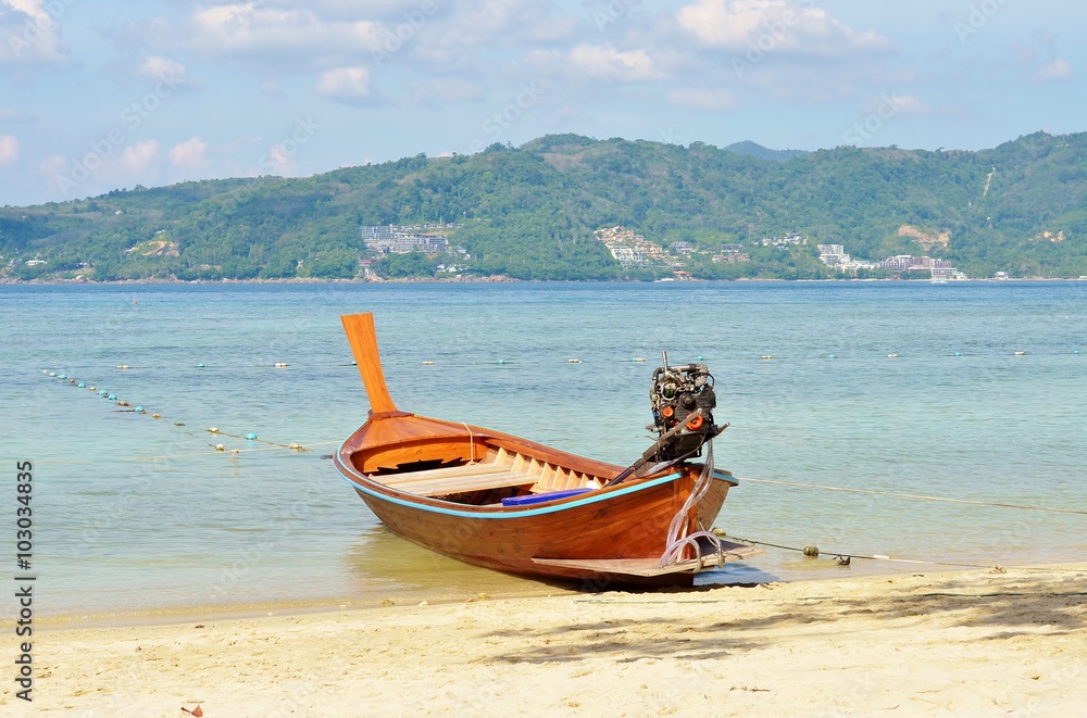 Thai boat on the beach against the backdrop of sea and mountains Thai boat on the beach against the backdrop of sea and mountains