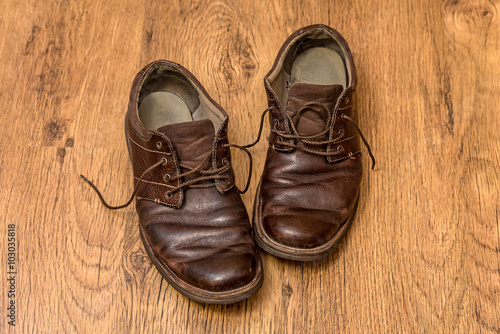 Men's old boots on wood background