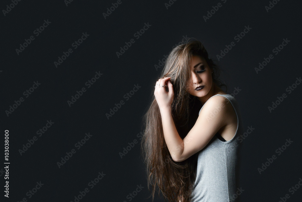 Obraz premium long hair brunette on black background