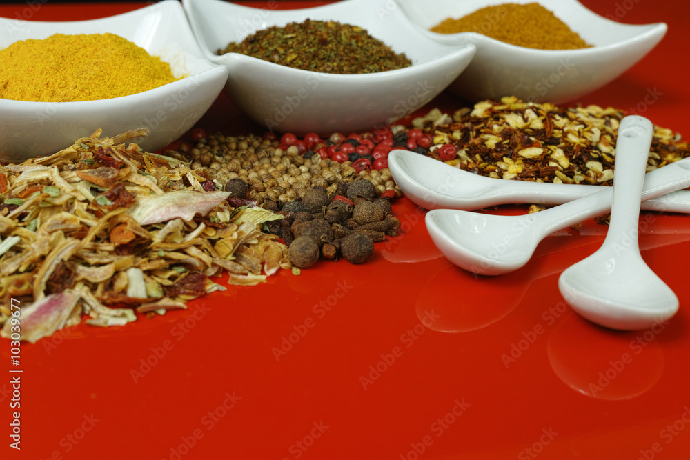 Set of spices and seasonings with white spoons, white on red Set of spices and seasonings with white spoons, white on red