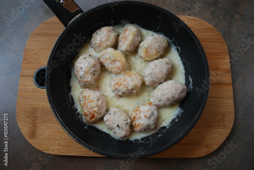 Turkey cutlets with sauce in the pan.