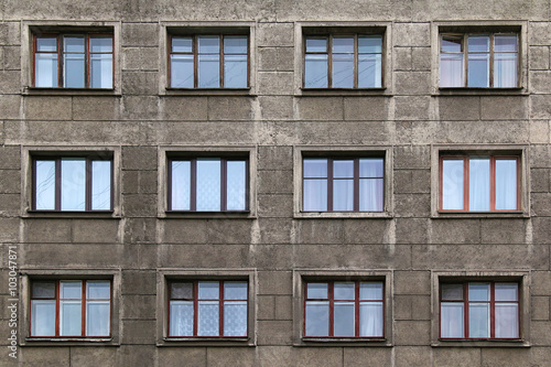 Many windows in row on facade of urban apartment building front view, St. Petersburg, Russia.
