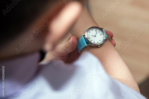 Boy looking at his wrist kid watch