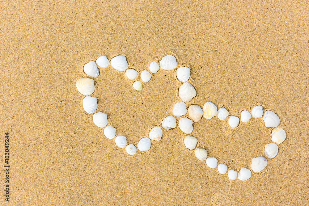 sea shell hearts on the sand beach