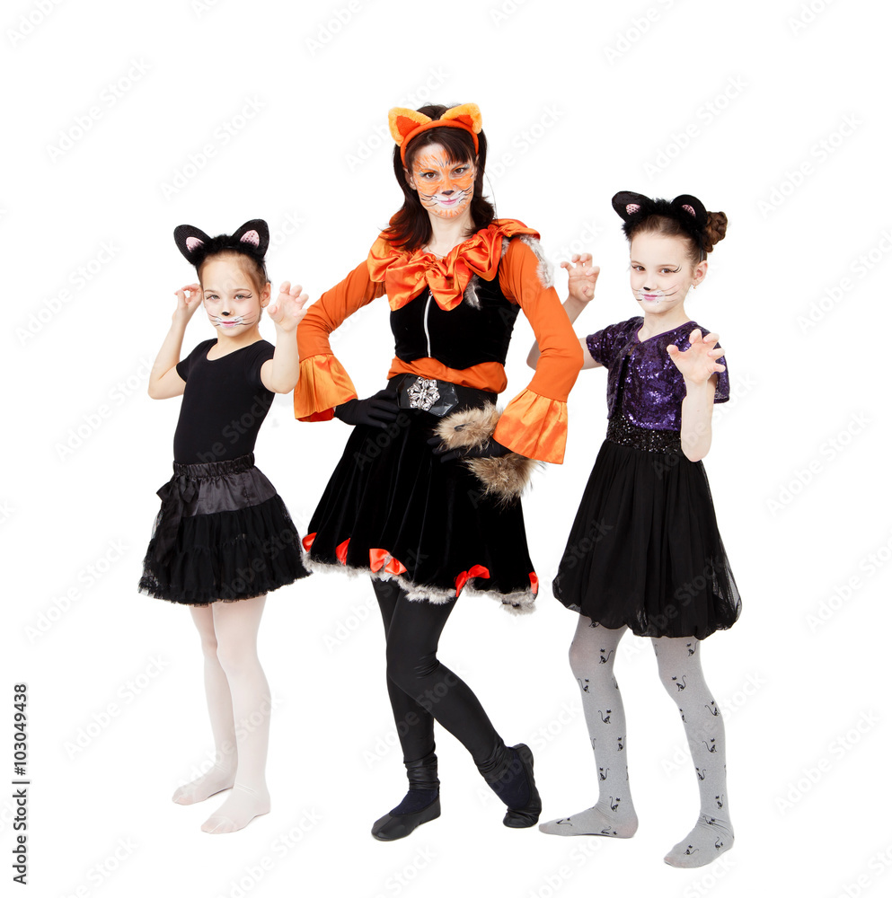 Young woman and two girls in cat carnival costumes posing Young woman and two girls in cat carnival costumes posing