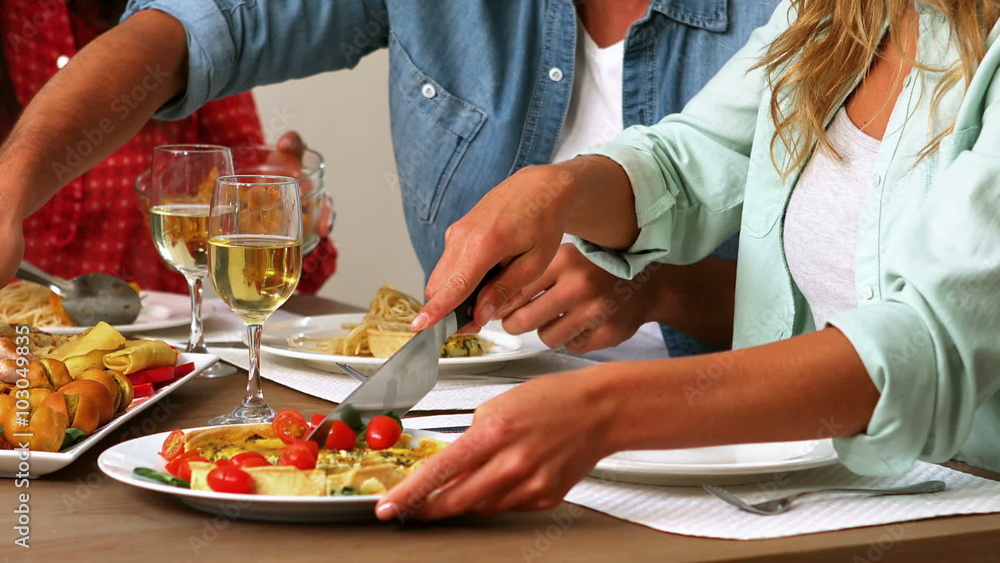 Happy young friends eating food with wine Happy young friends eating food with wine