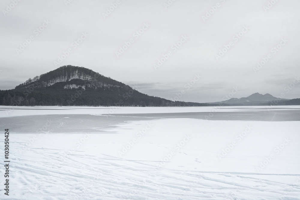 photo of frozen lake Machovo jezero with trace of the winter tourism in Czech republic photo of frozen lake Machovo jezero with trace of the winter tourism in Czech republic