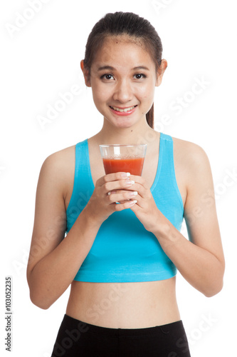 Beautiful healthy Asian girl with tomato juice
