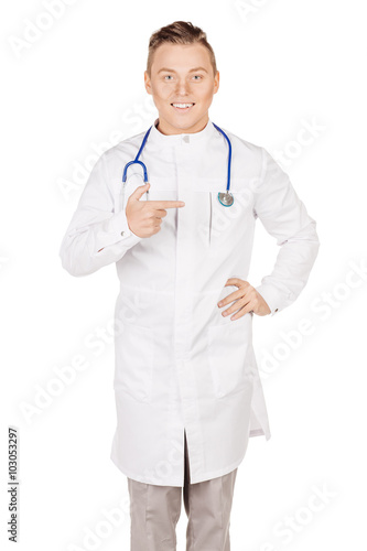 Young male doctor in white coat and stethoscope finger point up