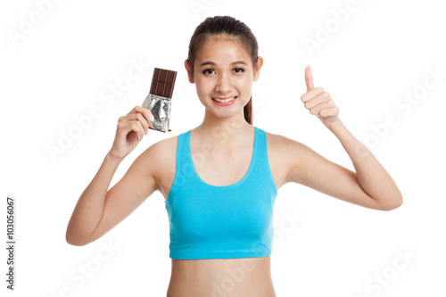 Beautiful healthy Asian girl thumbs up with chocolate
