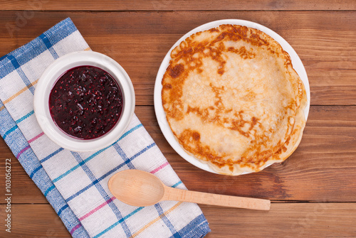 Fried pancakes and jam on the kitchen table.