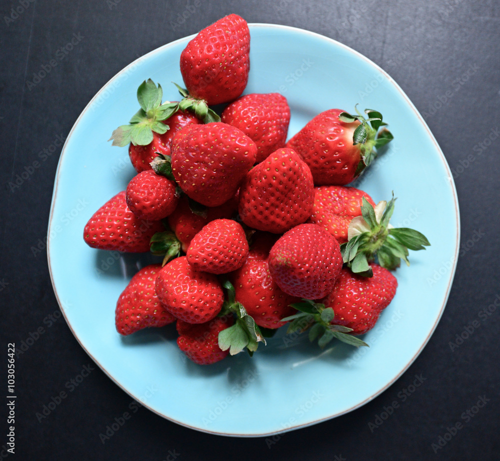 Strawberris on plate on blackboard Strawberris on plate on blackboard