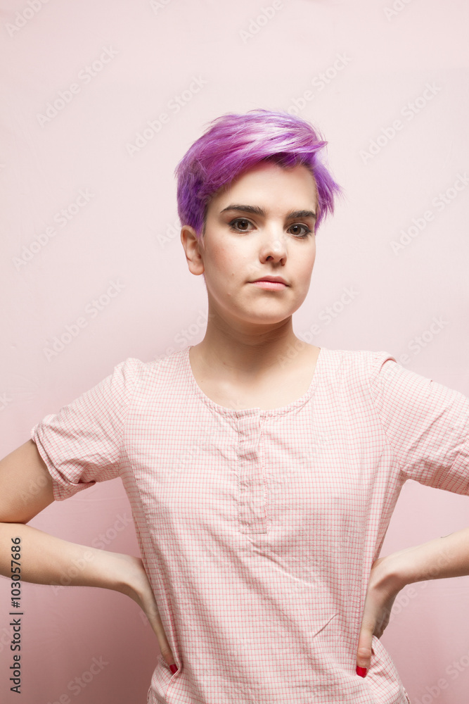 Violet-short-haired woman in pink pastel standing with her hands Violet-short-haired woman in pink pastel standing with her hands