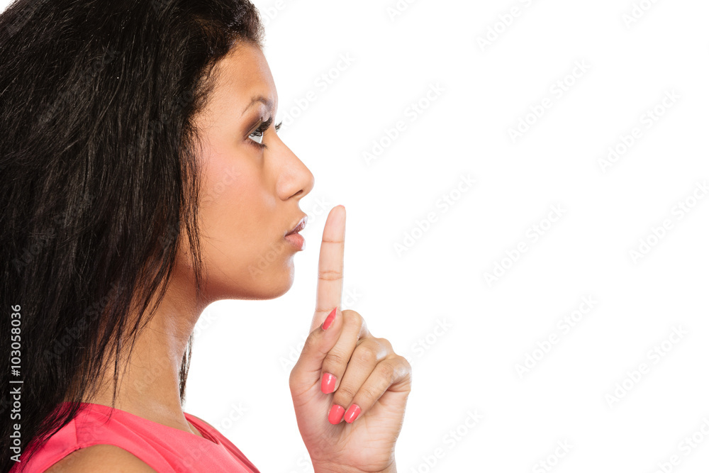 Woman with finger on lips showing silence gesture. Woman with finger on lips showing silence gesture.