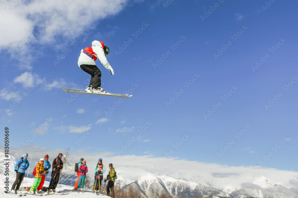 Skier instructor doing high jump above the mountain