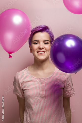 Violet short-haired woman in pink pastel, with falling balloons. © pablocroatto