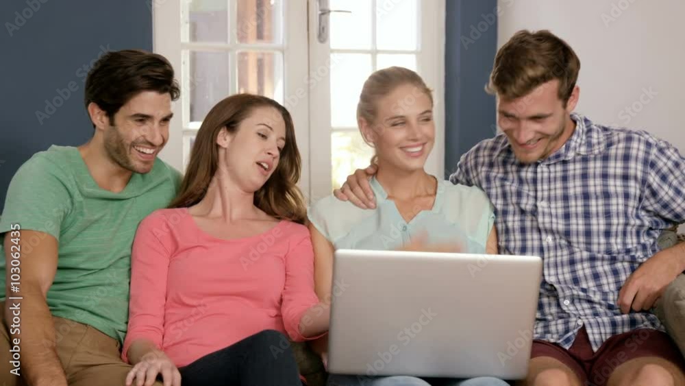 Happy couples using laptop together Happy couples using laptop together