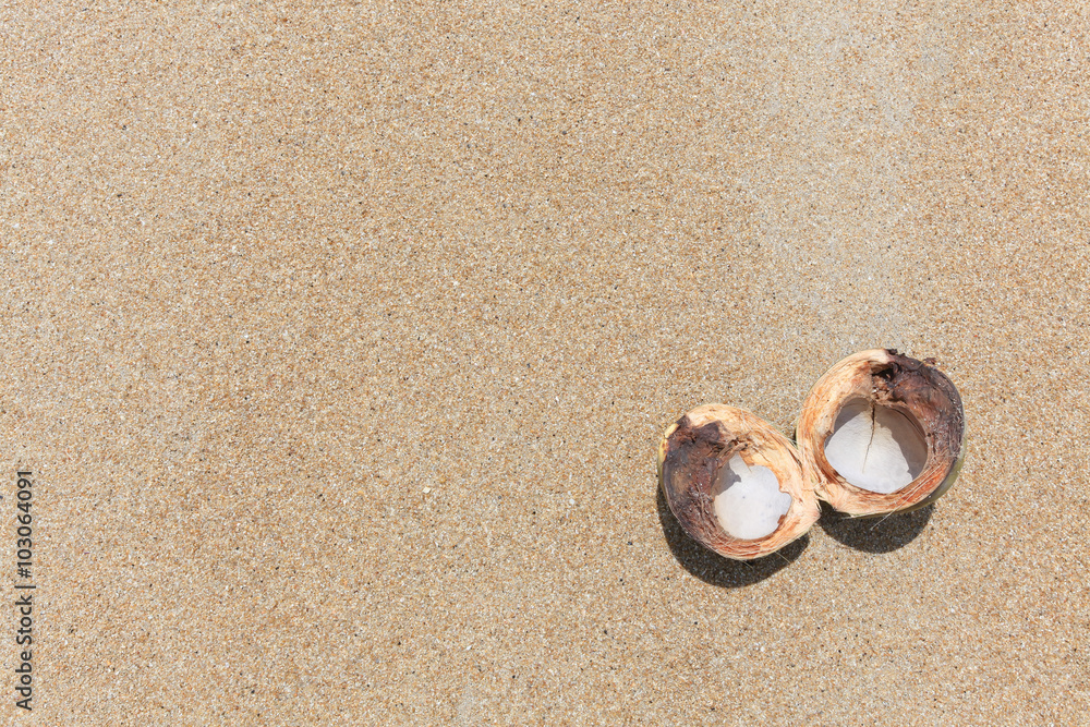Opened coconut on the sand