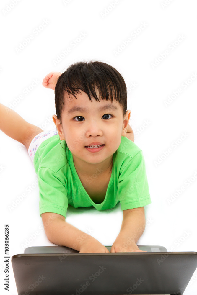 Chinese little girl lying down with laptop Chinese little girl lying down with laptop