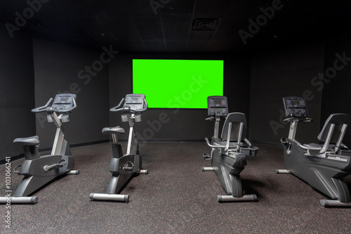 Four Exercise Bikes In Room with Green Screen For Replacement