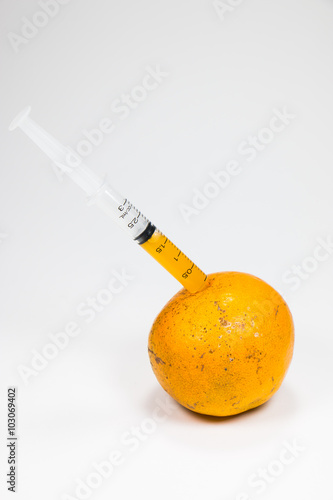 A real orange fruit was sucked with syringe