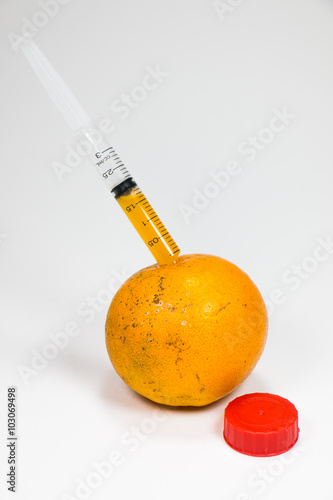 A real orange fruit was sucked with syringe