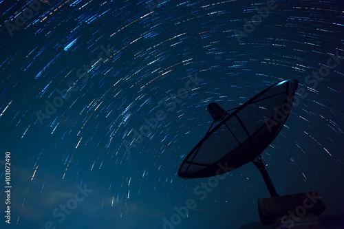 Satellite Dish and Star Trails. Blue sky.