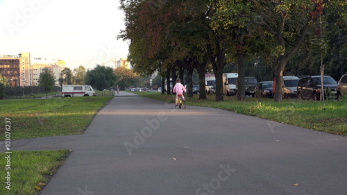 Wallpaper Mural St. Petersburg, RUSSIA-September 28, 2014, little girl rides a bicycle on the pavement Torontodigital.ca