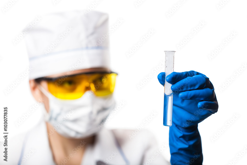Woman chemist examines test tube Woman chemist examines test tube