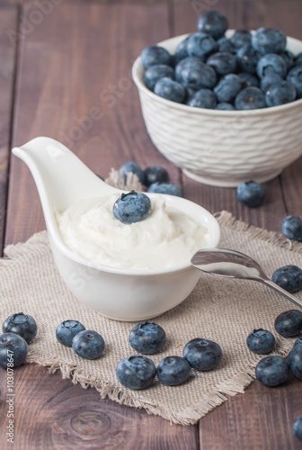 White bowl with yogurt and blueberries