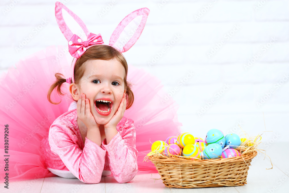 Happy child girl in a costume Easter bunny rabbit with basket of Happy child girl in a costume Easter bunny rabbit with basket of