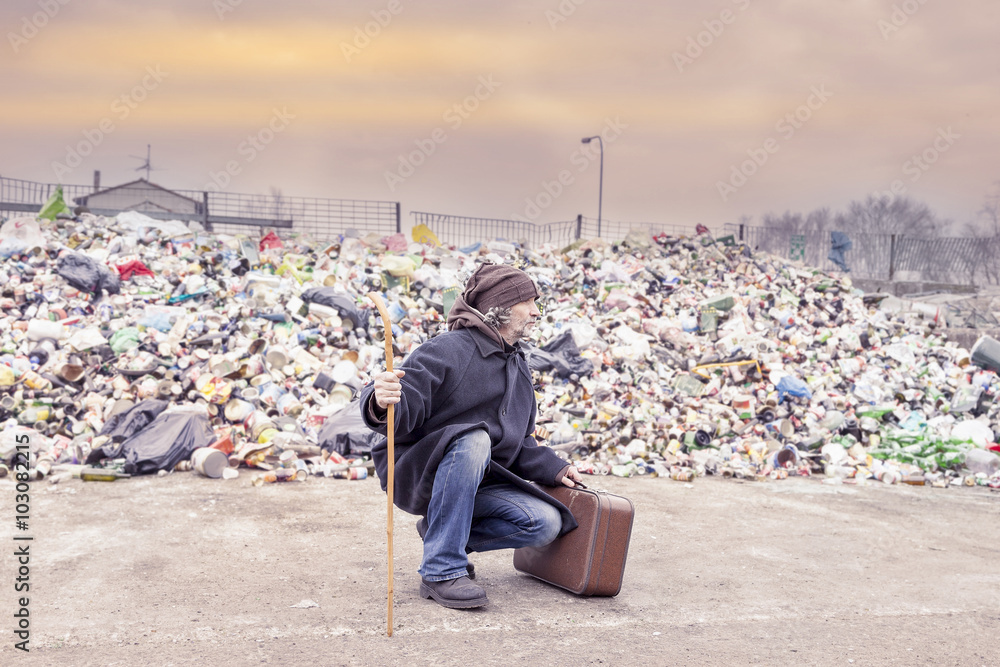 homeless with suitcase lives in landfill