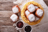 Sweet beignets with powdered sugar and jam. Horizontal top view 
