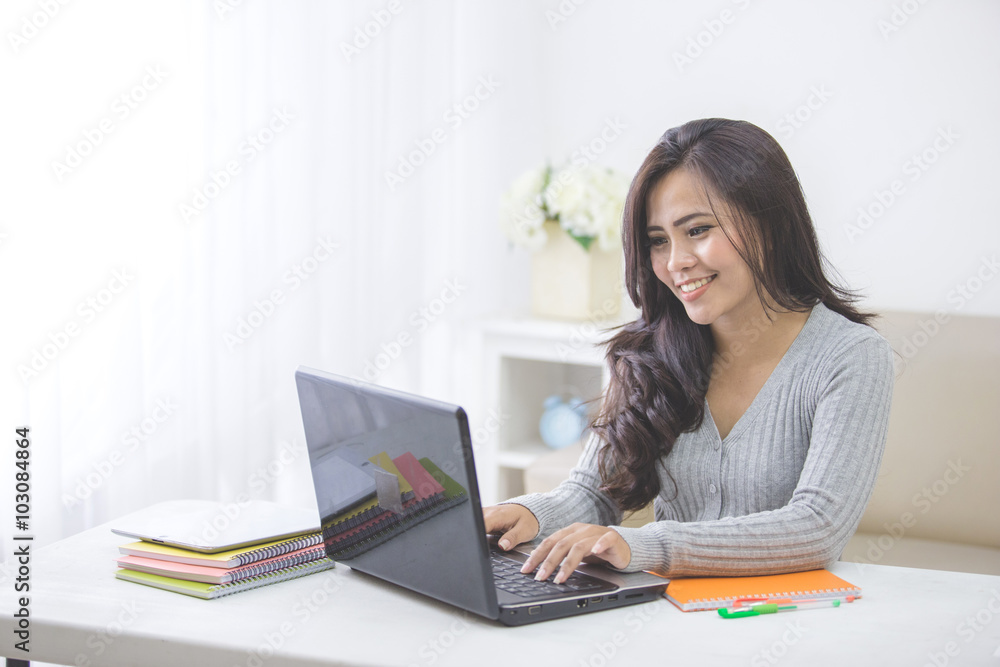 asian female student at home studying using laptop asian female student at home studying using laptop