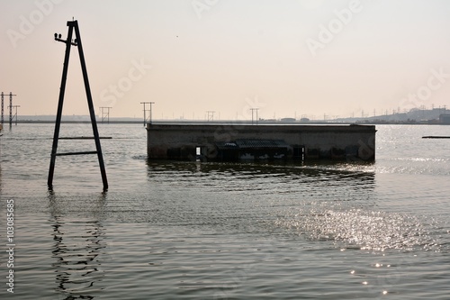 Pylons flooded by lake near Lokbatan, Azerbaijan. A recently flooded landscape shows signs of its previous state in Lokbatan, 15km south west of Baku
 photo