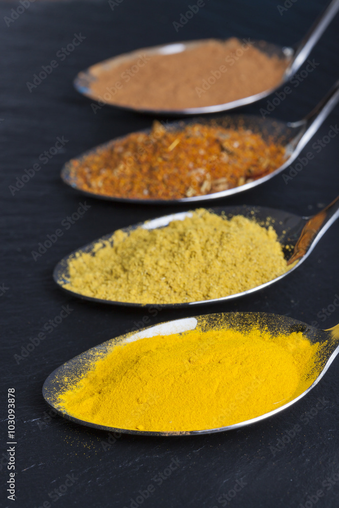 oriental indian spices curry paprika nutmeg on slate oriental indian spices curry paprika nutmeg on slate