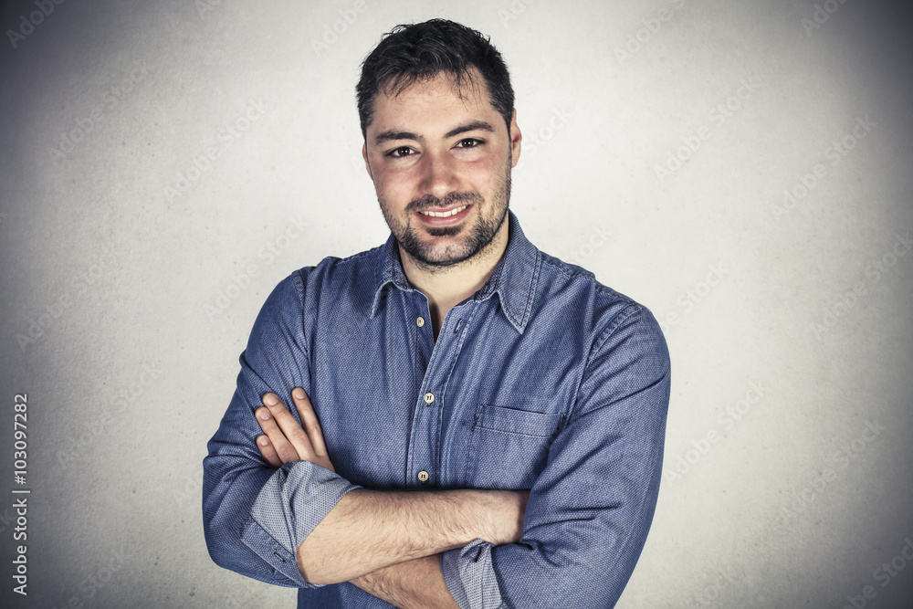 Young handsome businessman isolated on a wall background Young handsome businessman isolated on a wall background
