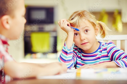 Siblings are doing homework photo