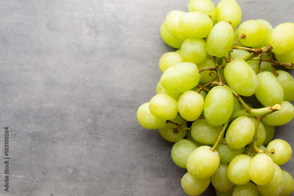 Grape cluster on the grey background. Grape cluster on the grey background.