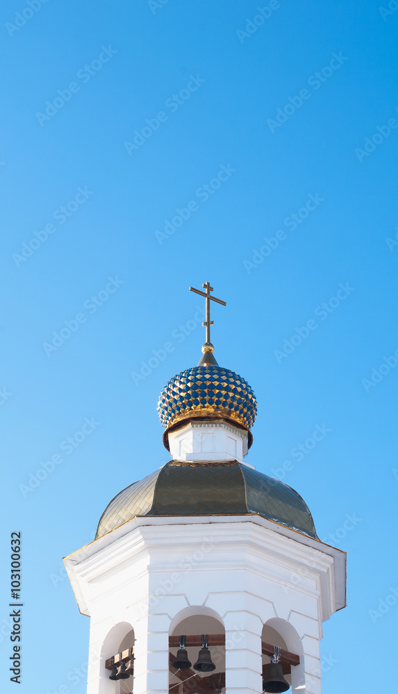 Church tower with bells and orthodox cross