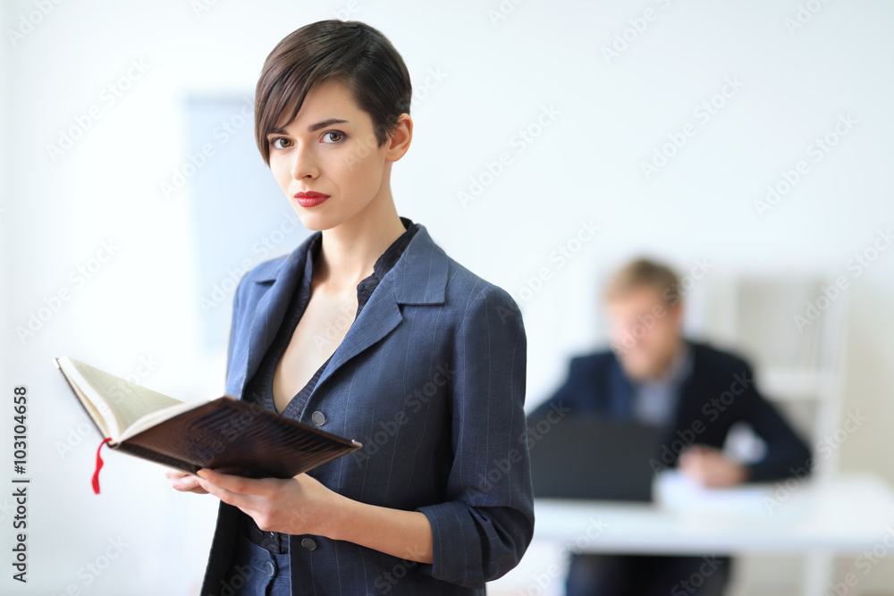 Portrait of young beautiful business woman with notebook Portrait of young beautiful business woman with notebook