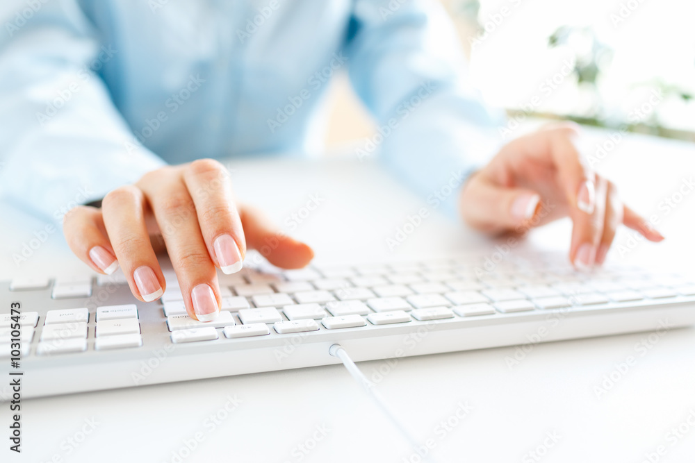 Woman office worker typing on the keyboard Woman office worker typing on the keyboard