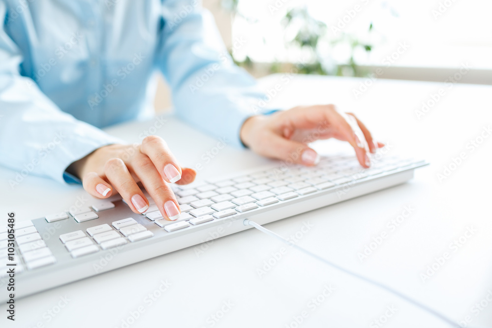 Woman office worker typing on the keyboard Woman office worker typing on the keyboard